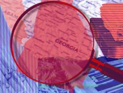 Magnifying glass over the map of Georgia